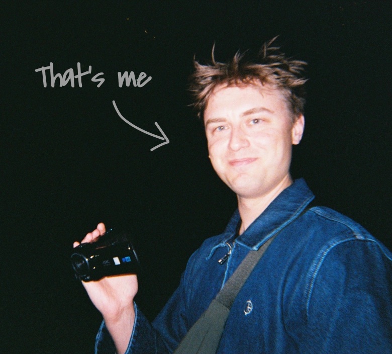 Me at night holding a video camera, with “That’s me” handwritten beside me