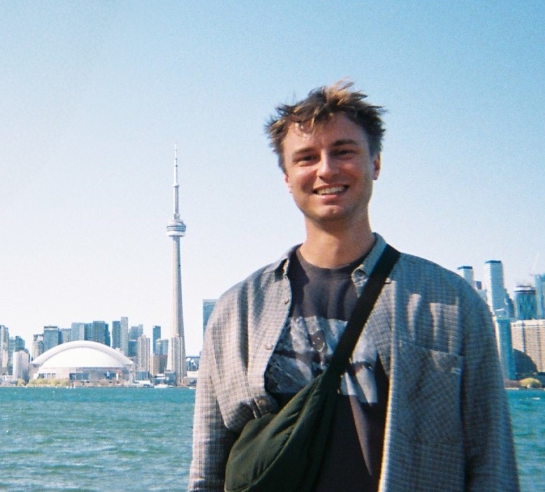 Me, smiling in front of the Toronto skyline, with “That’s me” handwritten beside me